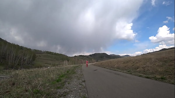 Mature milf with naked charms walks on a public road outdoors. Exhibitionist with a gorgeous ass and hairy pussy. PAWG and amateur fetish.